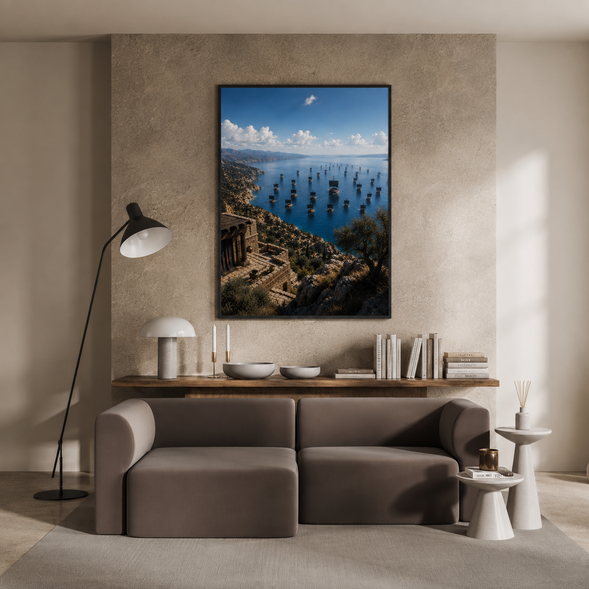 A large framed vertical art print depicting a scenic coastal harbor with many small boats, hung on a textured beige wall above a modern gray sofa in a styled living room.